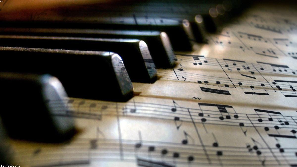 An acoustic piano and a digital piano side by side