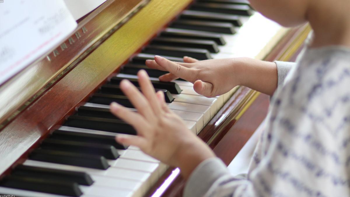 A person practicing piano, tracking their learning progress over time