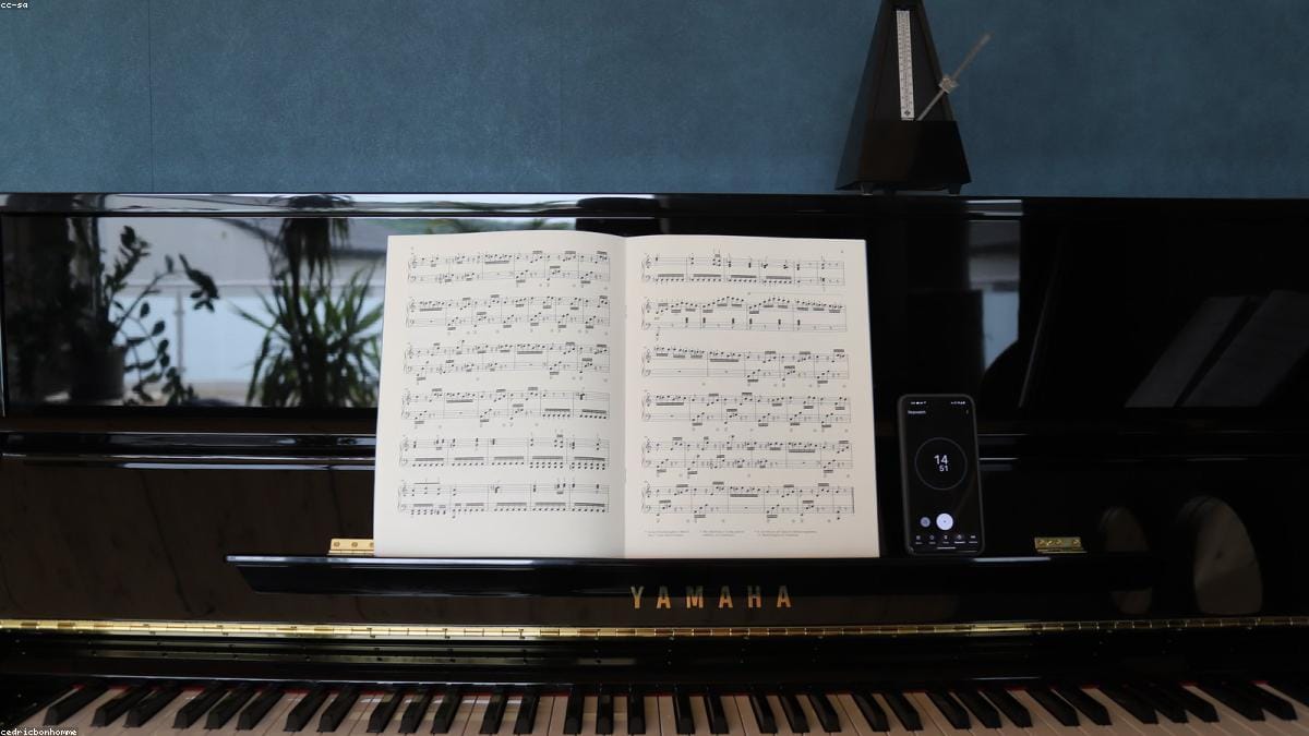 A pianist memorizing a piece from sheet music